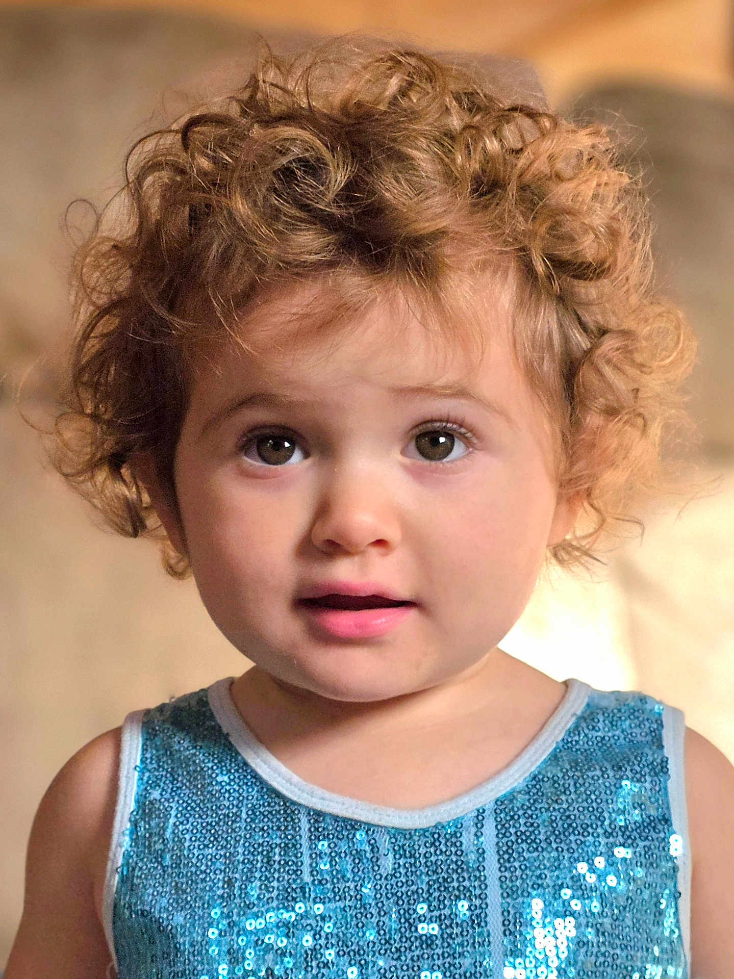 Gianna joined the competition — help win amazing prizes! toddler, child, curly_hair, blue_sequin_top, face, portrait, indoor, young_child, cute, eyes, expression, fashion, person, closeup, skin, hair, innocent, looking, warm_light, soft_background