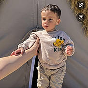 Qassym participe au concours pour gagner de l'argent avec cette photo : casual, child, clothing, curious, daylight, hand, lion_king, nature, outdoor, pants, person, portrait, sneakers, standing, straw, sunlight, sweatshirt, tent, toddler, young_child