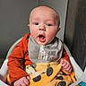 baby, child, infant, portrait, sitting, high_chair, wide_eyed, open_mouth, surprised, orange_clothing, bib, tiger_blanket, stuffed_toy, activity_toy, colorful, indoor, home, curtain, close_up, smiling