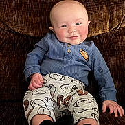 Noah is registered to the contest to win money with this photo: baby, black_socks, blue_sweater, casual, child, clothing, couch, eyes, face, football_pants, hands, happy, indoor, infant, photography, portrait, sitting, smiling, sportswear, upholstery