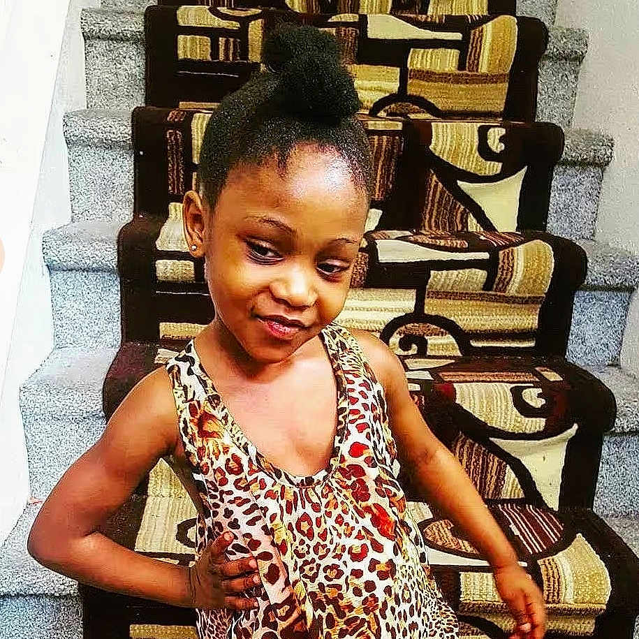 Trinity joined the competition — help win amazing prizes! blackhair, bodypart, child, clothing, cornrows, curlyhair, dimples, face, female, girl, hair, head, mohawkhairstyle, neck, person, shoulder, sitting, sleeve