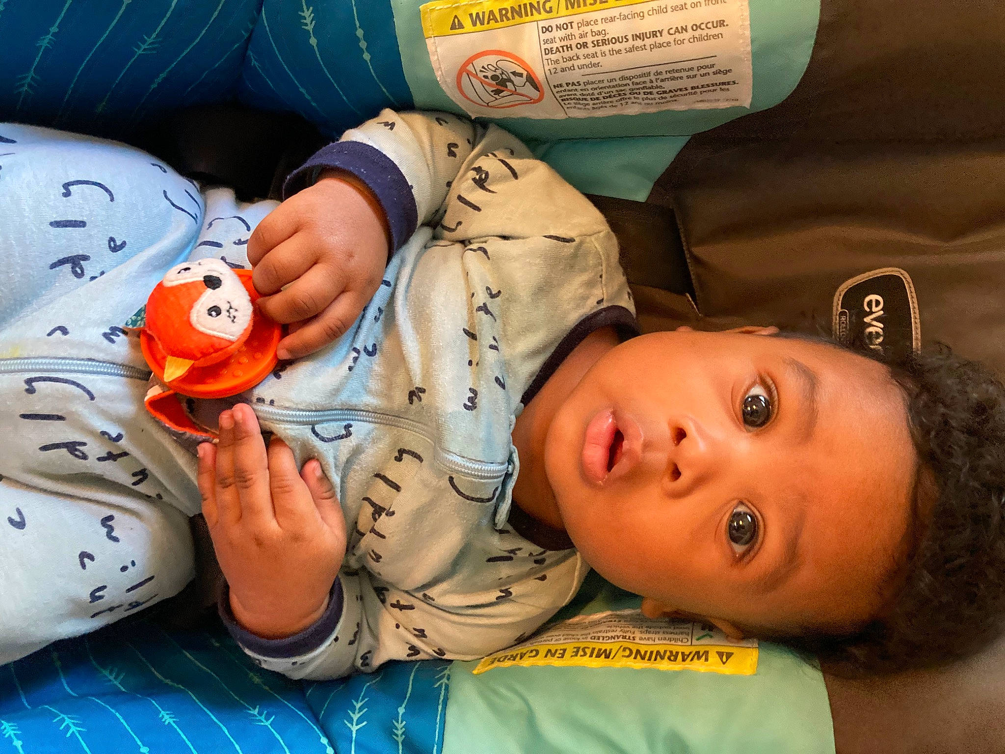 Kenneth is registered to the contest to win money with this photo: baby, baby_toddler_clothing, carmine, cheek, child, comfort, finger, fun, happy, linens, mouth, nail, nose, orange, person, play, product, room, surprise, textile