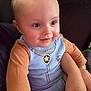 Jaxson is registered to the contest to win money with this photo: adorable, baby, blue_eyes, child, clothing, comfort, couch, cute, face, hand, indoor, infant, onesie, person, rosy_cheeks, sitting, skin, smiling, support, young