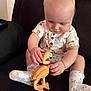 Jaxson joined the competition — help win amazing prizes! baby, child, comfortable, couch, curious, cute, face, flamingo, hands, indoor, infant, pajamas, patterned_clothing, playing, sitting, socks, soft_light, toy, wood, wooden_toy