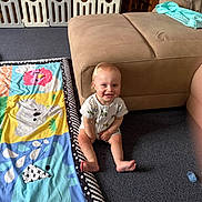 Jaxson joined the competition — help win amazing prizes! animal_print, baby, baby_gate, carpet, child, clothing, couch, cute, footwear, furniture, happy, home, indoor, infant, pacifier, person, play_mat, sitting, smiling, toy