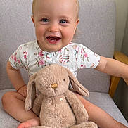 Jaxson joined the competition — help win amazing prizes! toddler, child, smiling, plush_toy, bunny, stuffed_animal, chair, cushion, floral_shirt, happy, indoors, portrait, cute, baby, sitting, cross_legged, toy, soft_toy, infant, light_skin