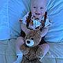 Jaxson is registered to the contest to win money with this photo: baby, bed, child, clothing, comfort, cute, expression, face, furniture, happy, indoor, infant, person, plush, portrait, sitting, smiling, socks, teddy_bear, toy