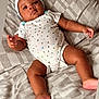 Tyriq joined the competition — help win amazing prizes! baby, infant, onesie, hat, blanket, patterned_clothing, lying_down, checkered_pattern, cute, relaxed, indoors, soft_lighting, child, adorable, portrait, young, skin, face, hand, foot