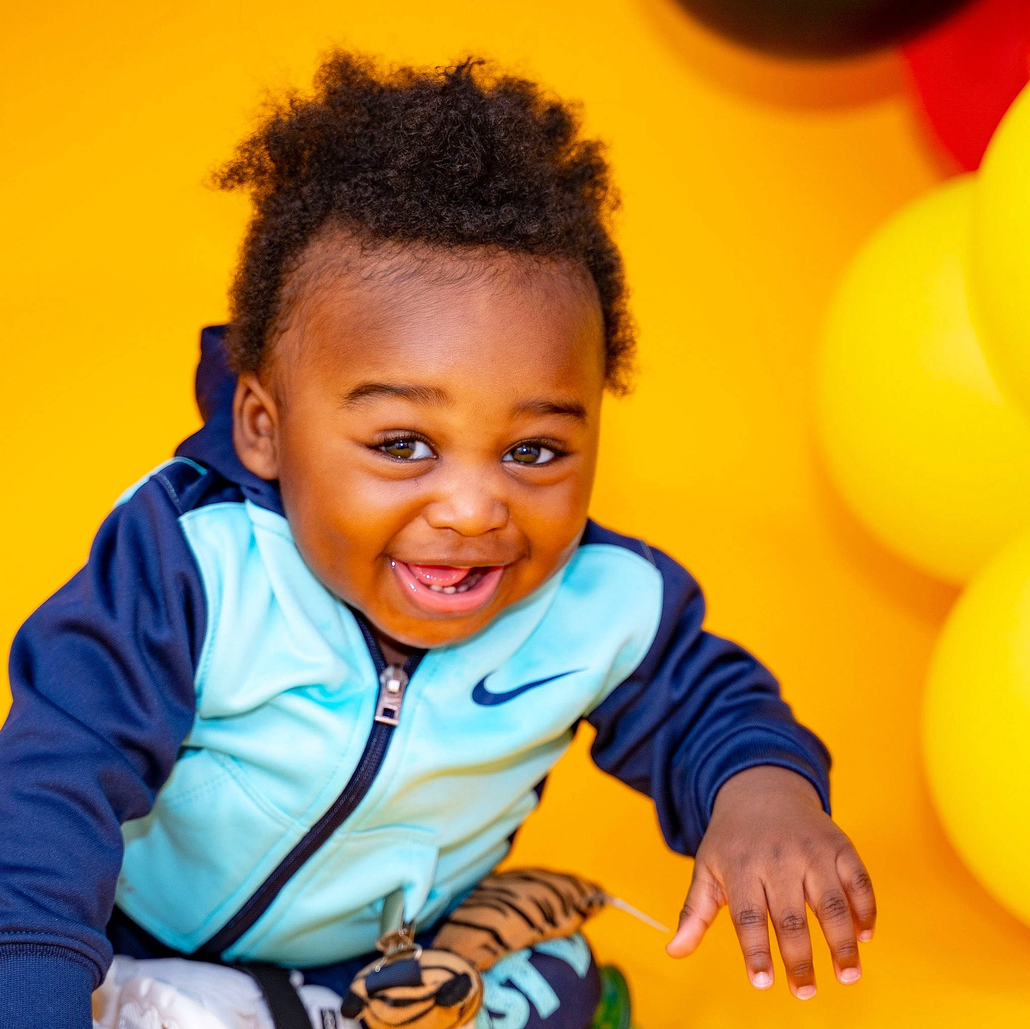 Jewel is registered to the contest to win money with this photo: black_hair, child, child_model, cool, facial_expression, fun, hairstyle, happy, joy, laugh, person, photography, play, sitting, smile, toddler, yellow