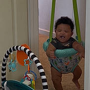 Khamari joined the competition — help win amazing prizes! baby, infant, child, jumper, baby_jumper, indoor, carpet, toy, activity_gym, play, happiness, smile, motion, home, doorway, green_straps, black_and_white_stripes, colorful, cute, fun