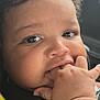 Khamari is registered to the contest to win money with this photo: baby, close_up, curly_hair, fingers, hand, face, child, cute, infant, portrait, skin, eyes, mouth, expression, car_seat, seatbelt, indoors, childhood, young, person