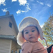 Brianna is registered to the contest to win money with this photo: autumn, baby, blanket, building, child, clouds, coat, curious, daylight, face, hat, house, nature, outdoor, person, portrait, sky, smiling, tree, warm_clothing