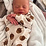 newborn, baby, sleeping, onesie, acorn_pattern, blanket, cozy, infant, hands, face, soft, cute, resting, indoor, bed, comfort, wrapped, peaceful, child, wearing