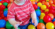 Anthony joined the competition — help win amazing prizes! ball_pit, blue_eyes, casual_clothing, child, colorful_balls, cute, fun, happy, indoor_play, plastic_balls, play_area, playtime, portrait, red_shirt, sitting, small_hands, smiling, striped_clothing, toddler, young_child