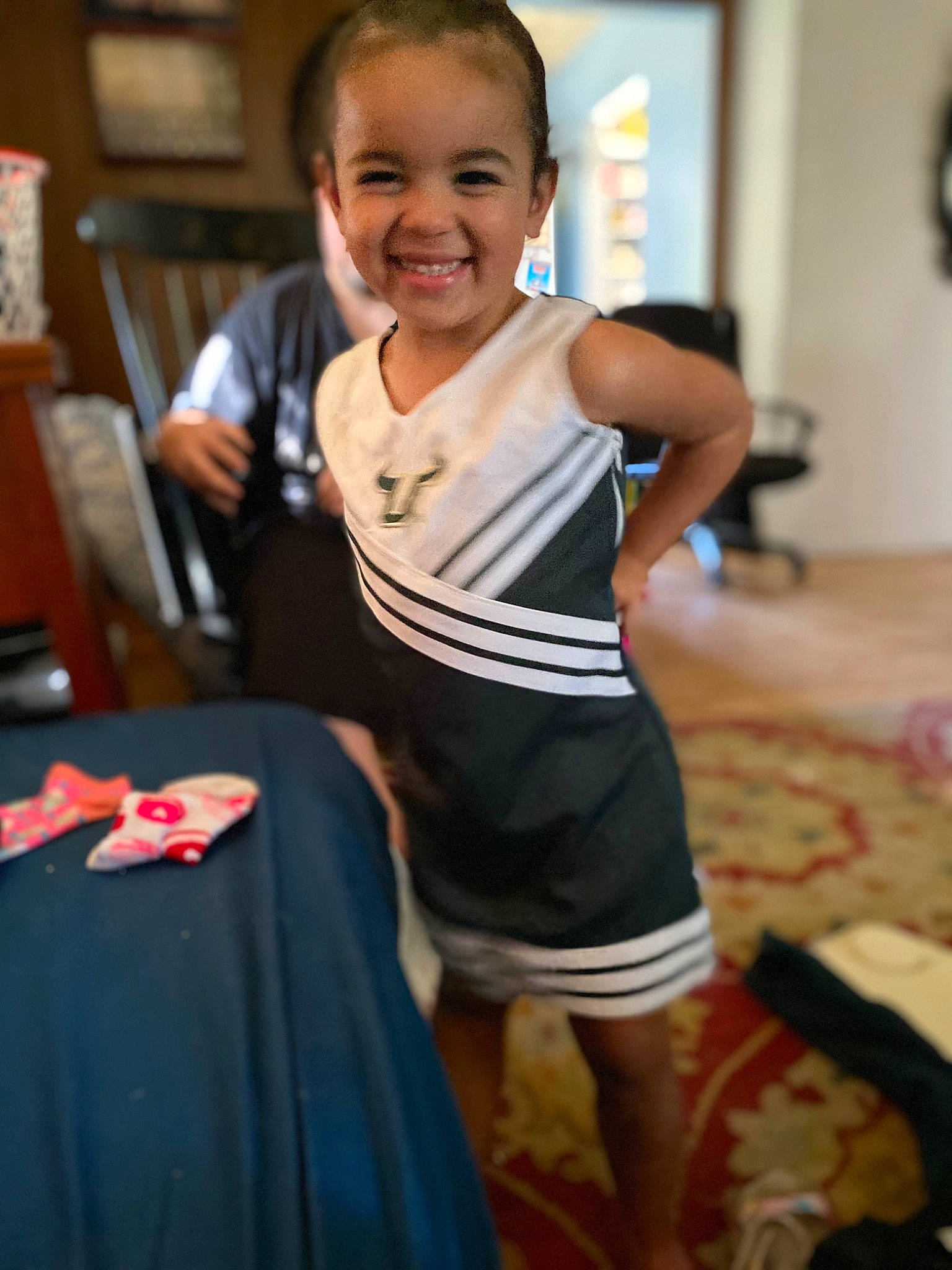 Royal is registered to the contest to win money with this photo: abdomen, child, event, face, flooring, fun, happy, human_leg, joy, knee, person, room, shorts, sitting, sleeve, smile, sportswear, t_shirt, thigh, toddler