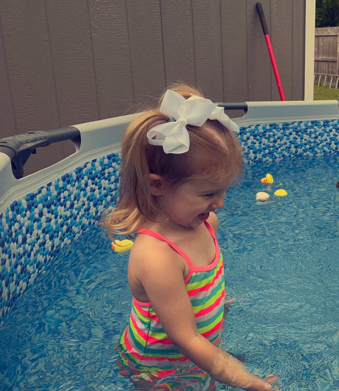 Cali is registered to the contest to win money with this photo: baby_toddler_clothing, bathing, bathroom, child, fashion_accessory, fun, happy, headpiece, leisure, pattern, person, play, plumbing, recreation, swimming_pool, toddler, vacation, water
