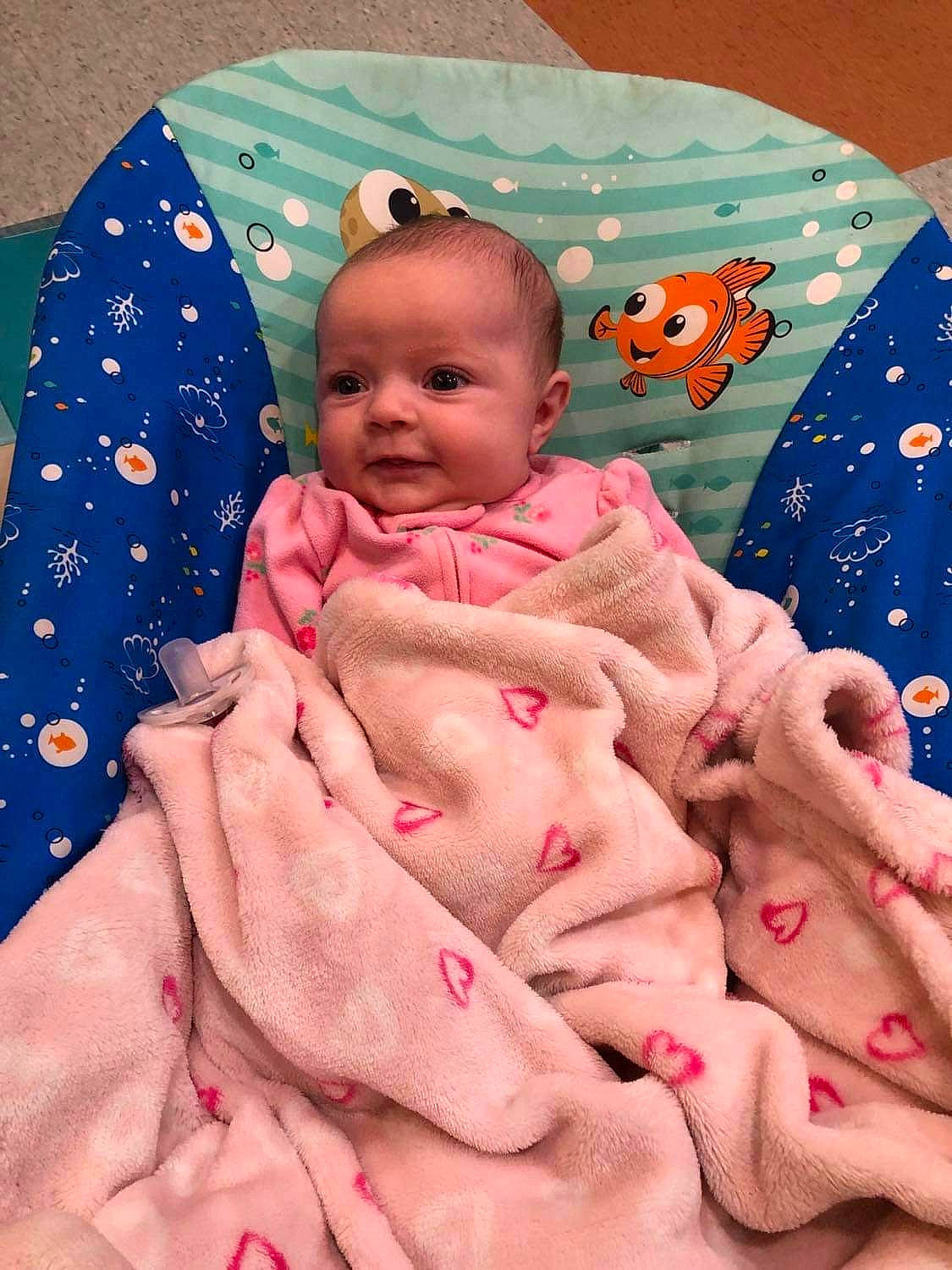 Emberlee is registered to the contest to win money with this photo: baby, baby_products, baby_toddler_clothing, cheek, child, comfort, face, facial_expression, happy, human, linens, mouth, person, pink, product, skin, sleeve, smile, textile, thumb