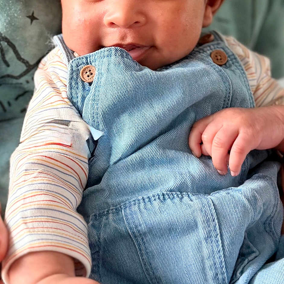 Zayn joined the competition — help win amazing prizes! baby, child, closeup, clothing, couch, cute, denim_overalls, eyes, face, hair, hand, happy, indoor, infant, person, pillow, portrait, skin, smile, striped_shirt
