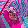 baby, infant, pink, float, pool, water, hat, bow, swimming, child, outdoor, sunlight, colorful, striped, cute, relaxing, summer, portrait, closeup, fun