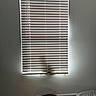 window_blinds, cat, shadow, basket, blanket, carpet, cat_toy, wall, indoor, home, lighting, shadow_play, pet, domestic, cozy, woven_basket, white_wall, floor, curtains, relaxation