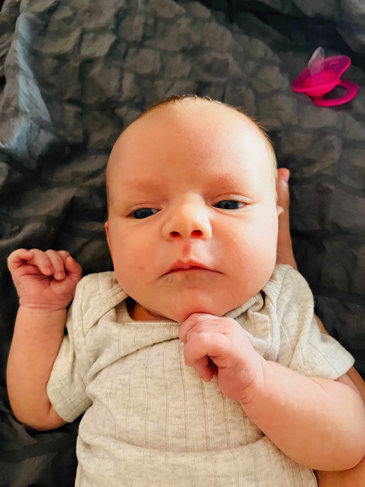 Renee joined the competition — help win amazing prizes! baby, infant, face, hand, clothing, pacifier, blanket, texture, skin, portrait, newborn, expression, lying_down, indoor, cute, child, soft_light, closeup, human, resting