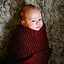 baby, infant, blanket, knit, maroon, wrapped, cozy, soft, fluffy, rug, texture, face, portrait, lying_down, child, cute, warm, skin, expression, indoors