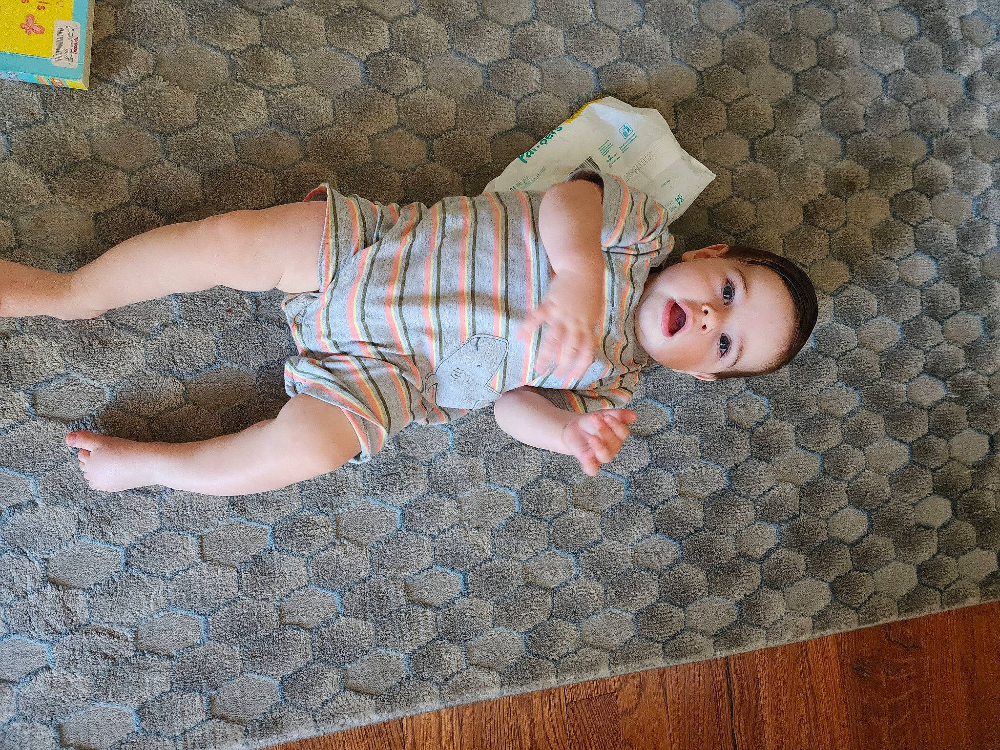 Albert is registered to the contest to win money with this photo: baby, baby_toddler_clothing, child, comfort, flooring, foot, hardwood, hat, human_leg, knee, linens, pattern, person, room, sitting, sleeve, sock, thigh, toddler, wood