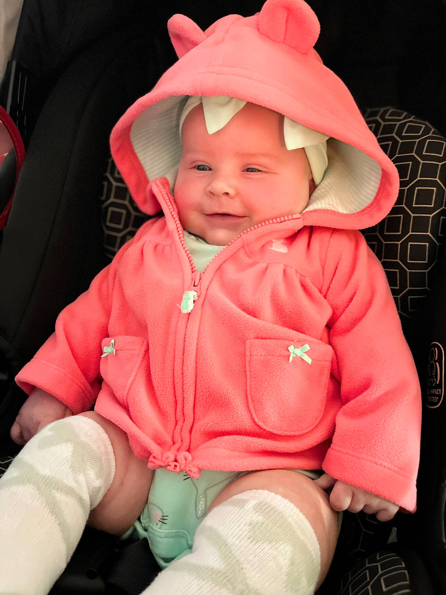 Rae joined the competition — help win amazing prizes! baby, baby_toddler_clothing, cap, cheek, comfort, eye, grass, happy, head, headwear, human_body, jacket, joy, lip, magenta, person, personal_protective_equipment, pink, sitting, skin