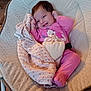 Farah participe au concours pour gagner de l'argent avec cette photo : baby, infant, smiling, pink_clothing, blanket, seat, cushion, indoor, child, face, happy, mickey_mouse, cute, person, portrait, cozy, soft, comfort, young_child, resting