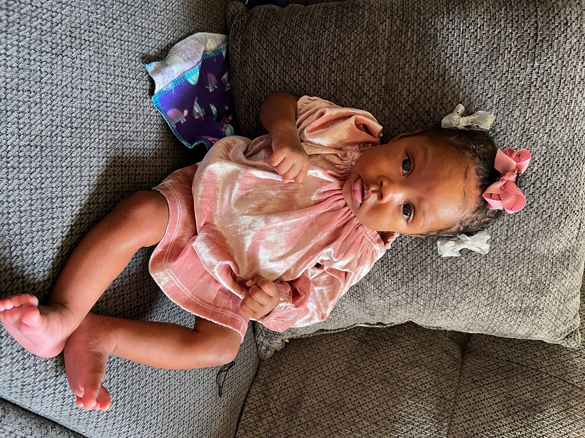 Phallon joined the competition — help win amazing prizes! baby, baby_toddler_clothing, child, comfort, doll, dress, flooring, foot, human_leg, knee, lap, leg, linens, nap, person, pink, room, sitting, skin, thigh