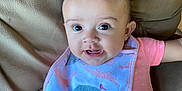 Raelynn is registered to the contest to win money with this photo: baby, bib, bodypart, chair, clothing, couch, cushion, face, furniture, happy, head, homedecor, laughing, mouth, person, photography, portrait, sitting, t_shirt, teeth