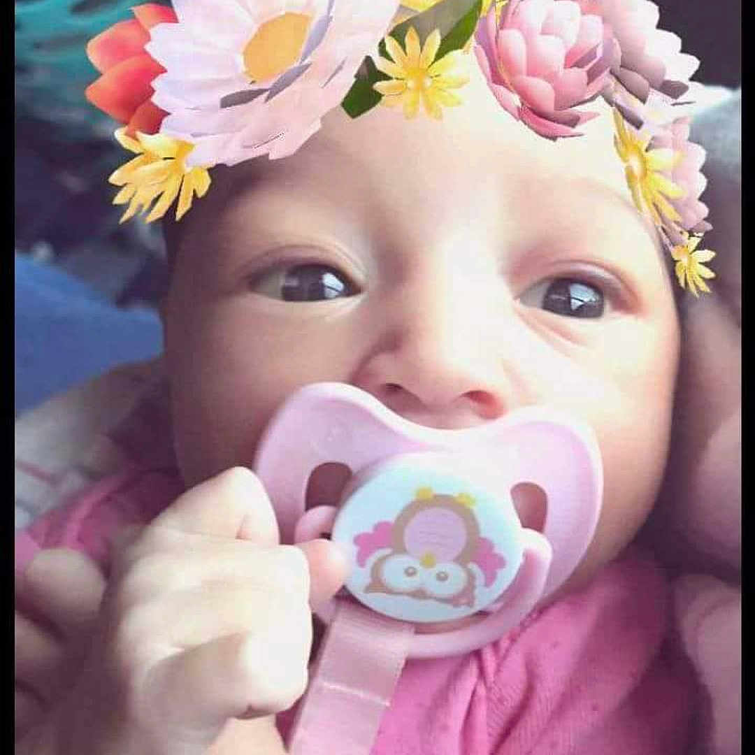Goddess is registered to the contest to win money with this photo: cake_decorating, cheek, child, face, finger, flower, girl, hair_accessory, hand, infant, lip, mouth, petal, pink, product, skin, smile, sweetness, toddler