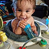 Mateo joined the competition — help win amazing prizes! baby, bottle, walker, child, toy, happy, indoor, person, smile, face, blue, furniture, play, seat, home, cute, hand, head, skin, infant