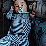 Mateo joined the competition — help win amazing prizes! baby, pacifier, striped_onesie, blanket, pajama_pants, cartoon_character, lying_down, indoor, child, infant, comfort, soft_texture, cute, sleepwear, relaxing, face, hands, blue_eyes, wooden_buttons, fabric