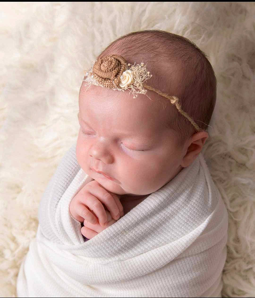 Elliana is registered to the contest to win money with this photo: baby, baby_toddler_clothing, cheek, chin, ear, eye, eyebrow, eyelash, face, gesture, hand, head, headband, headgear, headpiece, human_body, lip, neck, person, sleeve
