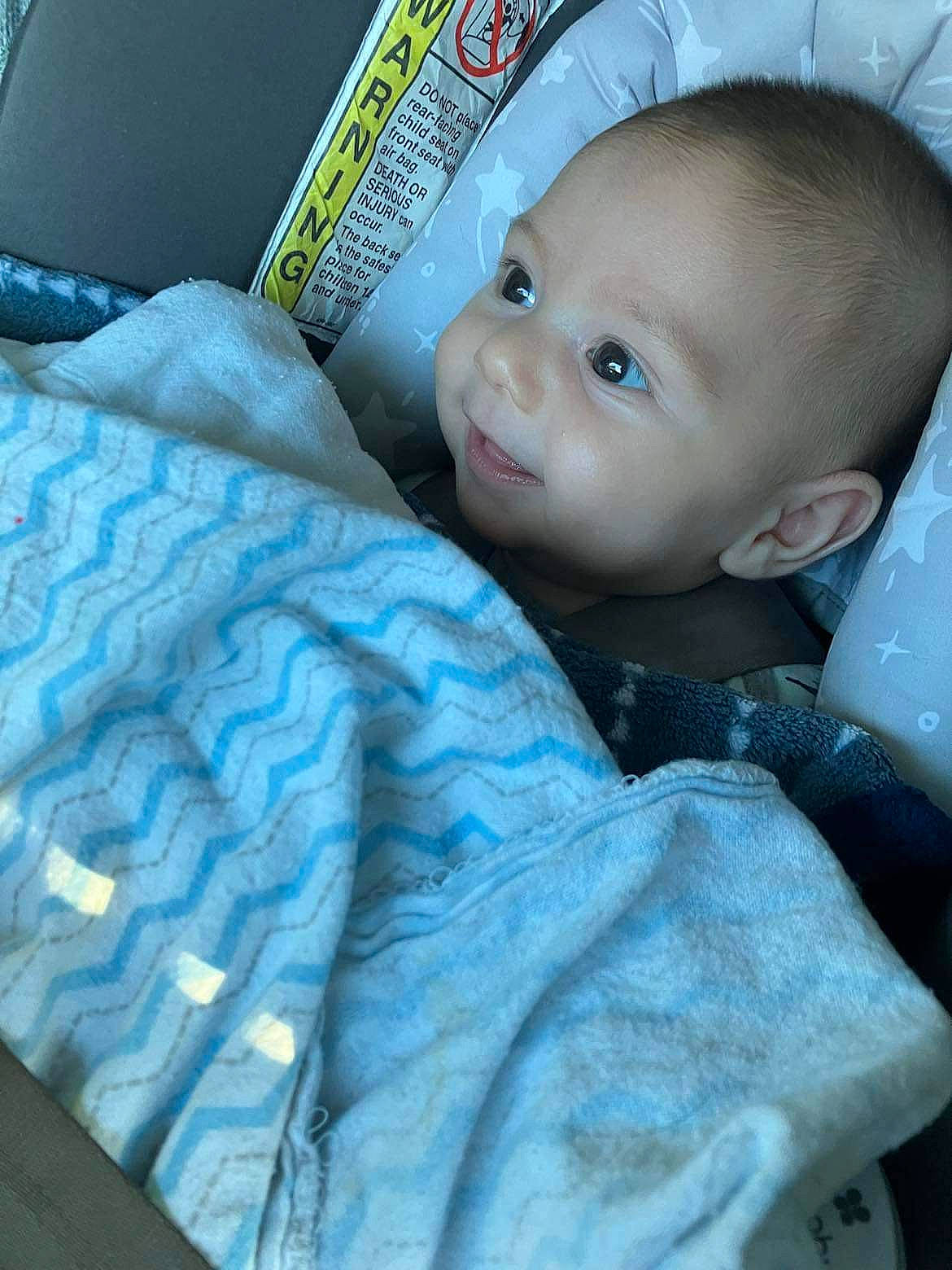 Camden is registered to the contest to win money with this photo: baby, baby_carriage, baby_products, baby_safety, baby_toddler_clothing, car_seat, cheek, child, comfort, electric_blue, eyelash, linens, person, room, sitting, sleeve, smile, toddler