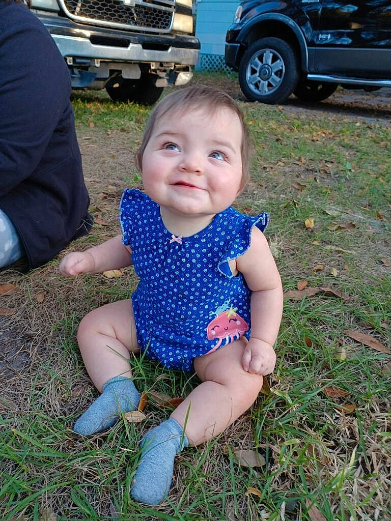 Mackenzie joined the competition — help win amazing prizes! automotive_exterior, automotive_tire, baby, baby_toddler_clothing, blue, car, eye, grass, happy, head, iris, joy, lawn, motor_vehicle, person, plant, smile, t_shirt, tire, toddler