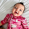 Harlie joined the competition — help win amazing prizes! baby, blue_eyes, camouflage_pattern, child, cute, expression, face, happy, head, indoors, infant, lying_down, onesie, person, pink_clothing, portrait, smiling, soft_surface, wearing, young