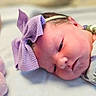 Harlie joined the competition — help win amazing prizes! newborn, baby, infant, headband, purple_bow, swaddled, floral_blanket, plush_toy, pink, soft, resting, portrait, cute, child, indoors, closeup, face, sleepy, peaceful, baby_girl