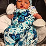 baby, infant, newborn, blue_butterfly, hat, mittens, blanket, cushion, plush_star, clothing, pattern, cute, face, person, indoors, portrait, seated, baby_seat, soft_toys, child