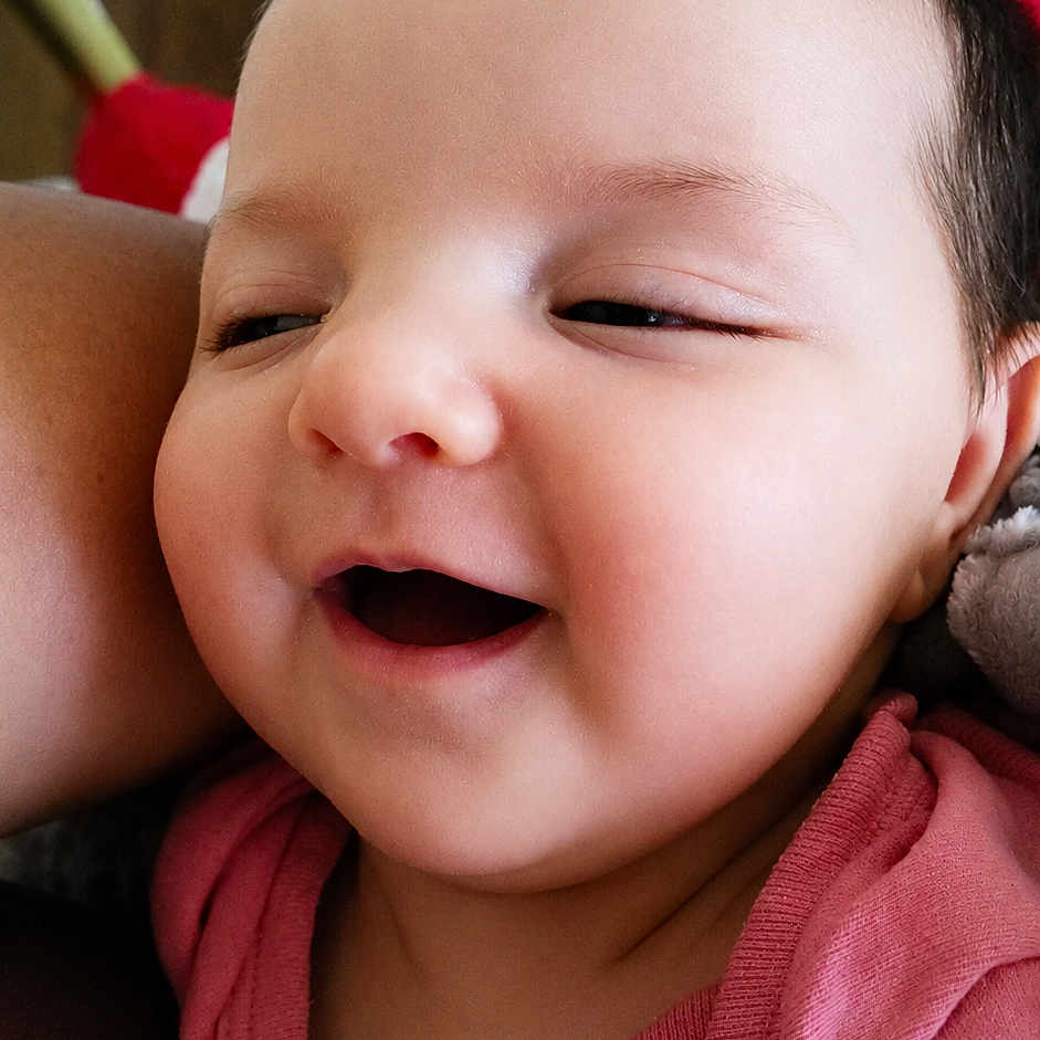 Harlie is registered to the contest to win money with this photo: baby, smiling, face, infant, child, pink_clothing, closeup, happy, cute, skin, head, person, portrait, newborn, expression, indoors, human, toddler, warmth, snuggle