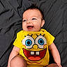 Harlie joined the competition — help win amazing prizes! baby, blanket, casual, child, cute, expression, face, hair, happy, human, indoors, infant, joyful, lying_down, onesie, portrait, skin, smiling, spongebob, yellow_clothing