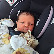 Harlie is registered to the contest to win money with this photo: newborn, baby, car_seat, blanket, mittens, face, infant, child, clothing, cushion, closeup, portrait, indoor, seatbelt, safety, head_support, soft, cute, sleepy, resting