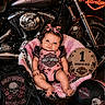 baby, basket, blanket, clothing, cute, decor, floor, harley_davidson, headband, helmet, indoor, infant, leather_jacket, motorbike, motorcycle, one_month_old, pink, portrait, sign, smile