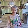 Ryder is registered to the contest to win money with this photo: appliance, avengers, boy, cabinet, cat, child, curly_hair, cute, floor, home, indoor, kitchen, light, marvel, person, smiling, sweatshirt, trash_can, window, wood_floor