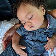 Nils is registered to the contest to win money with this photo: child, toddler, sleeping, denim, clothing, hand, resting, peaceful, portrait, close_up, face, hair, skin, baby, person, casual, indoor, comfort, nap, calm