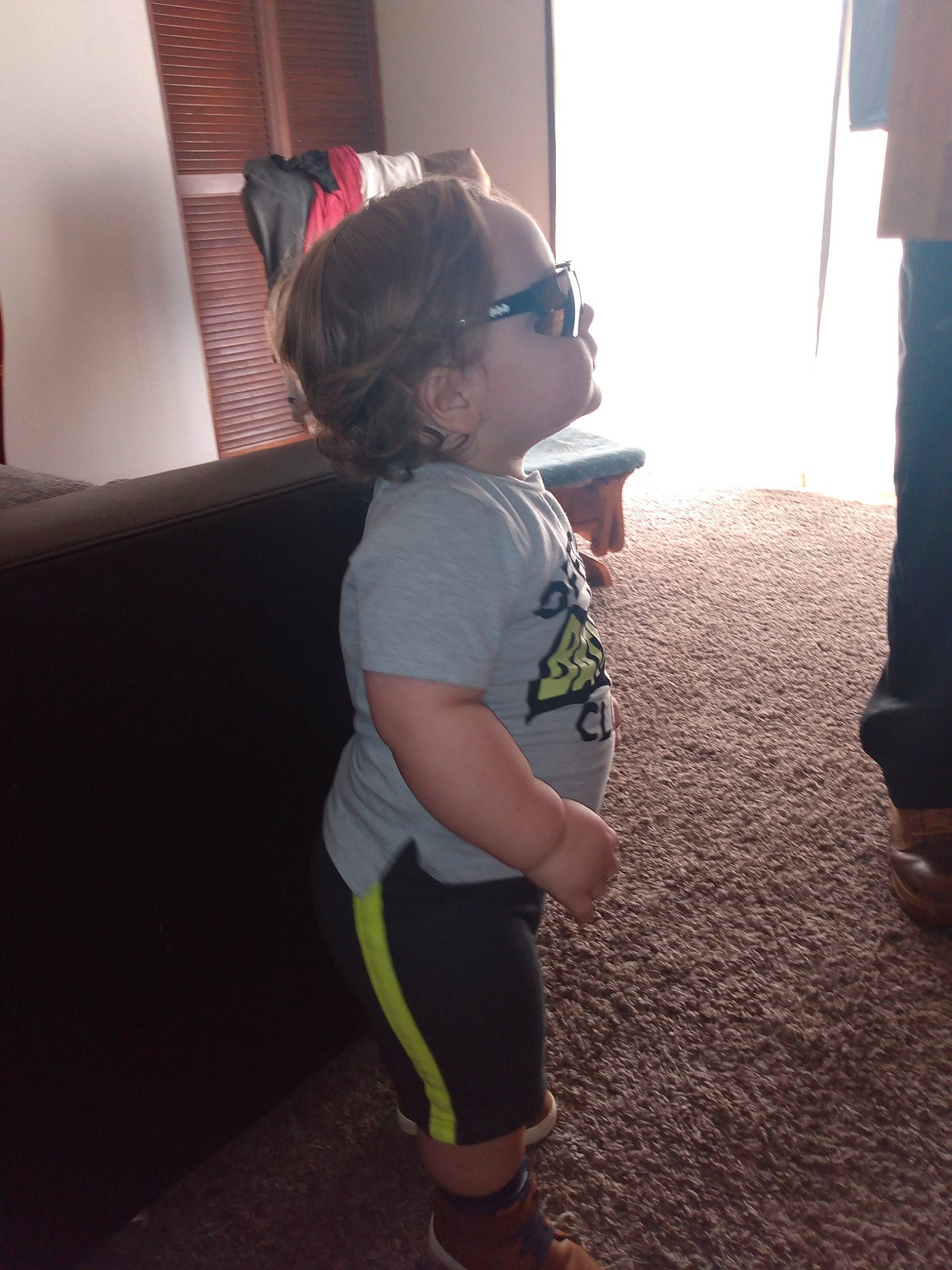 Danny joined the competition — help win amazing prizes! child, couch, eyewear, floor, flooring, fun, human_leg, knee, person, personal_protective_equipment, room, shadow, shorts, sitting, sleeve, t_shirt, thigh, toddler, vacation, vertebrate