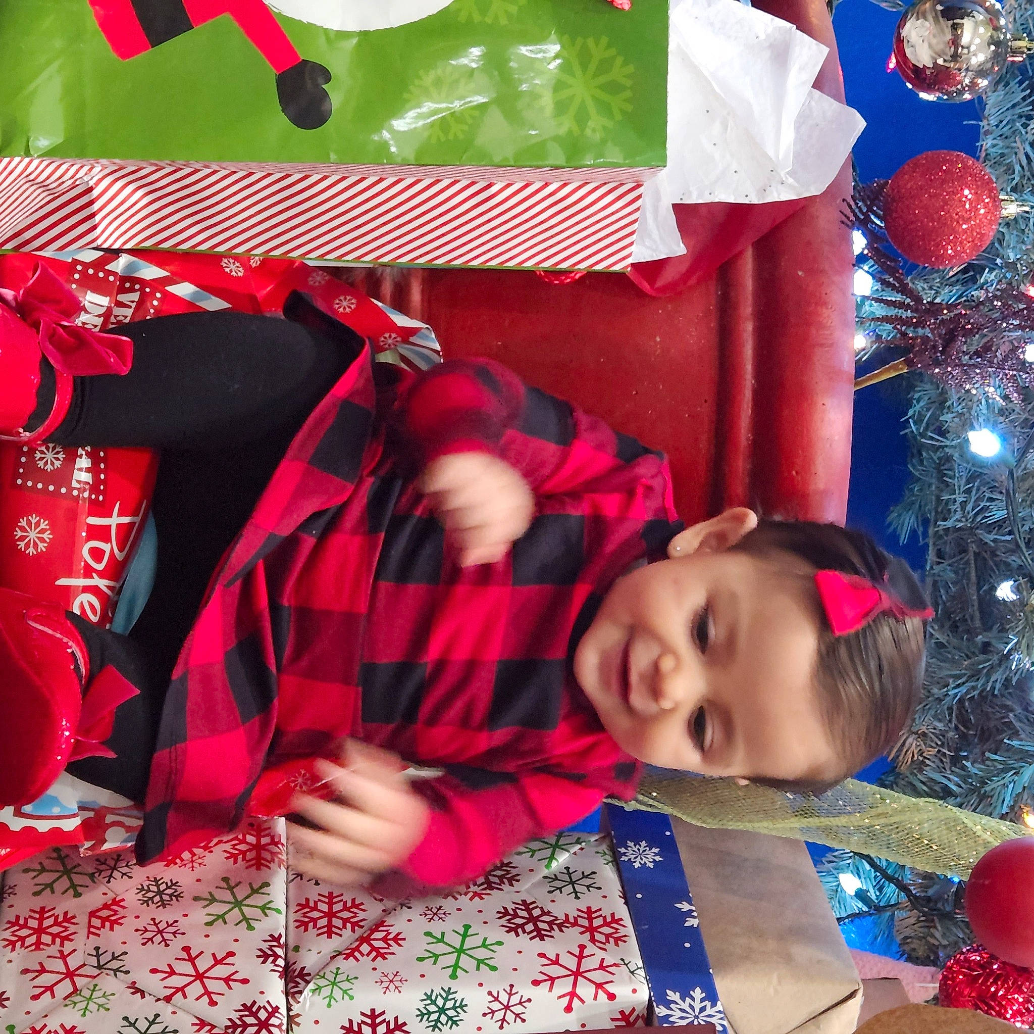 Hannah is registered to the contest to win money with this photo: baby_toddler_clothing, carmine, child, christmas, christmas_eve, cool, event, green, happy, holiday, joy, linens, pattern, person, play, red, room, smile, t_shirt, textile