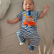 Lucas joined the competition — help win amazing prizes! baby, infant, child, striped_clothing, blue, white, orange, bed, blanket, socks, motion_blur, lying_down, cute, smiling, apparel, animal_applique, giraffe, car, indoor, person