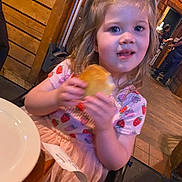 Callie joined the competition — help win amazing prizes! child, girl, bread, food, eating, strawberry_pattern, dress, restaurant, wooden_wall, high_chair, indoor, person, table, plate, cute, smiling, blonde_hair, casual_clothing, dining, happy